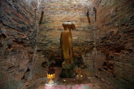 A religious figure is seen inside Sambor Prei Kuk, or "the temple in the richness of the forest" an archaeological site of ancient Ishanapura, a UNESCO world heritage site, in Kampong Thom province, Cambodia July 16, 2017. Picture taken July 16, 2017. REUTERS/Samrang Pring