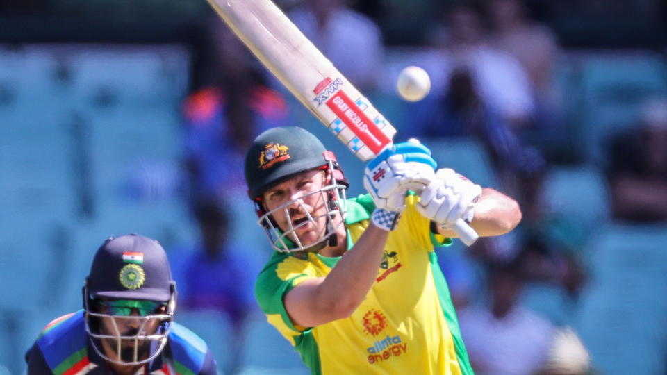 Seen here, Aaron Finch hits a ball towards the boundary in the first ODI against India.