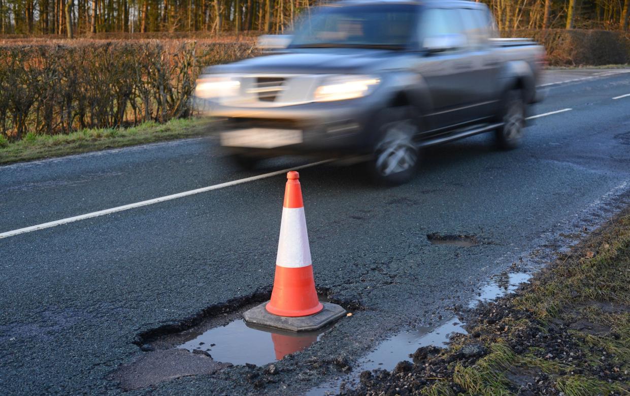 A road cone marking off a pothole on a road in Yorkshire