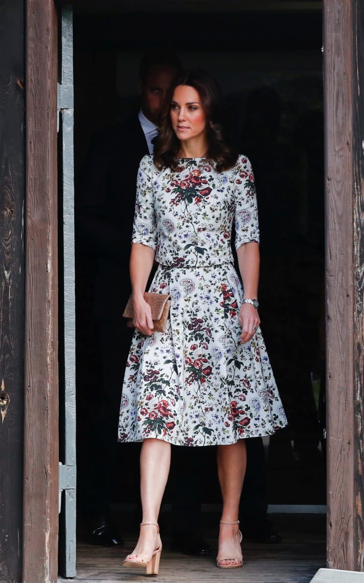 The Duchess chose a floral two-piece by Erdem.The fitted short-sleeved top and fit-and-flare midi skirt were paired with a pair of open-toed nude sandals by <a href="https://www.net-a-porter.com/gb/en/product/895602?cm_mmc=LinkshareUS-_-J84DHJLQkR4-_-Custom-_-LinkBuilder&siteID=J84DHJLQkR4-tJBR8MaFAHn3i.wLnUICaQ&ShopStyle+%28POPSUGAR%29=ShopStyle+%28POPSUGAR%29" rel="nofollow noopener" target="_blank" data-ylk="slk:Stuart Weitzman;elm:context_link;itc:0;sec:content-canvas" class="link ">Stuart Weitzman</a> and a clutch by Polish brand Etui [Photo: Getty]