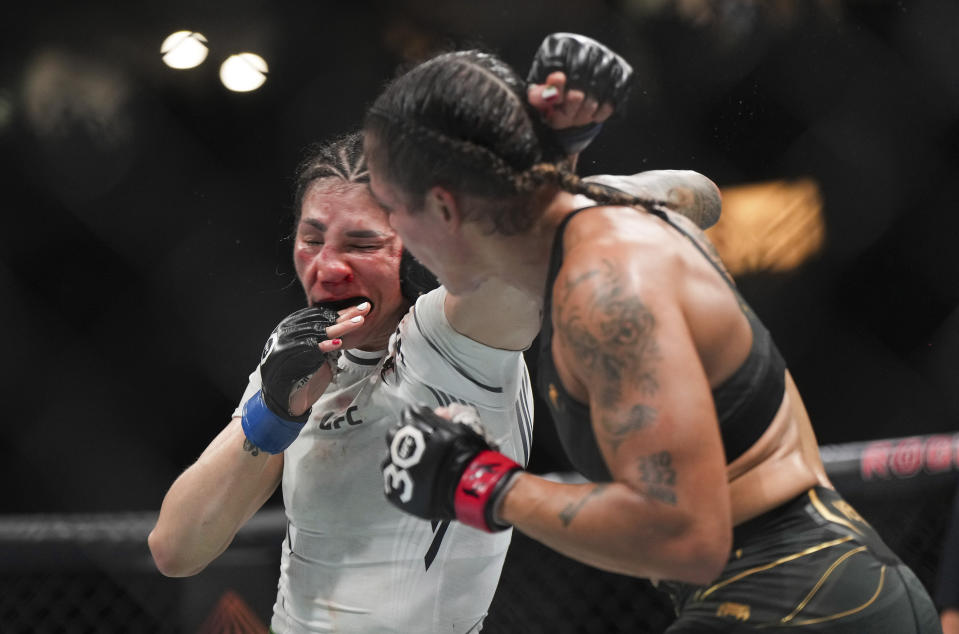 Amanda Nunes, front right, lands a punch to the face of Irene Aldana during a UFC 289 women's bantamweight title bout, in Vancouver, British Columbia, on Saturday, June 10, 2023. (Darryl Dyck/The Canadian Press via AP)