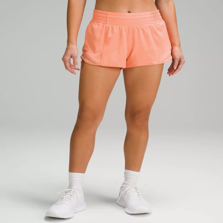 Image of model wearing orange shorts
