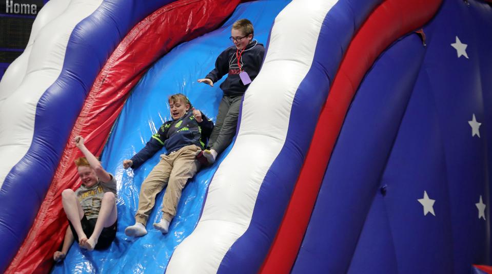 Children enjoy inflatables during the "Out of This World" dance party Friday, May 10, 2024, at Ravenna High School.