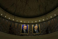 Pictures of Syrian president Bashar al-Assad and his father Hafez al-Assad are seen inside a hotel in Damascus, Syria, September 16, 2018. REUTERS/Marko Djurica/Files