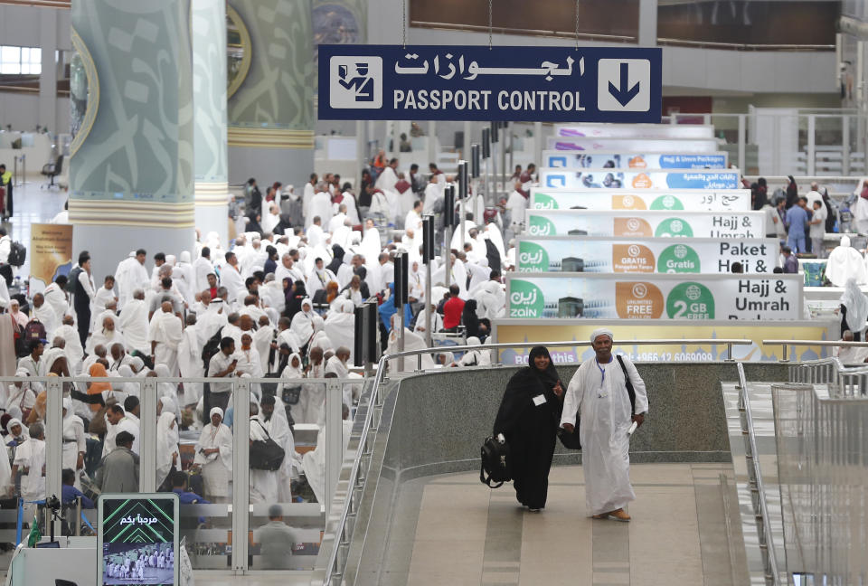 FILE - In this Saturday, Aug. 3, 2019 file photo, pilgrims arrive at the Hajj Terminal at Jiddah airport, Saudi Arabia. Over 2 million Muslims from around the world are beginning the five-day hajj pilgrimage on Friday. They will circle Islam's most sacred site, the cube-shaped Kaaba in Mecca, and take part in a series of rituals intended to bring about greater humility and unity among Muslims. (AP Photo/Amr Nabil, File)