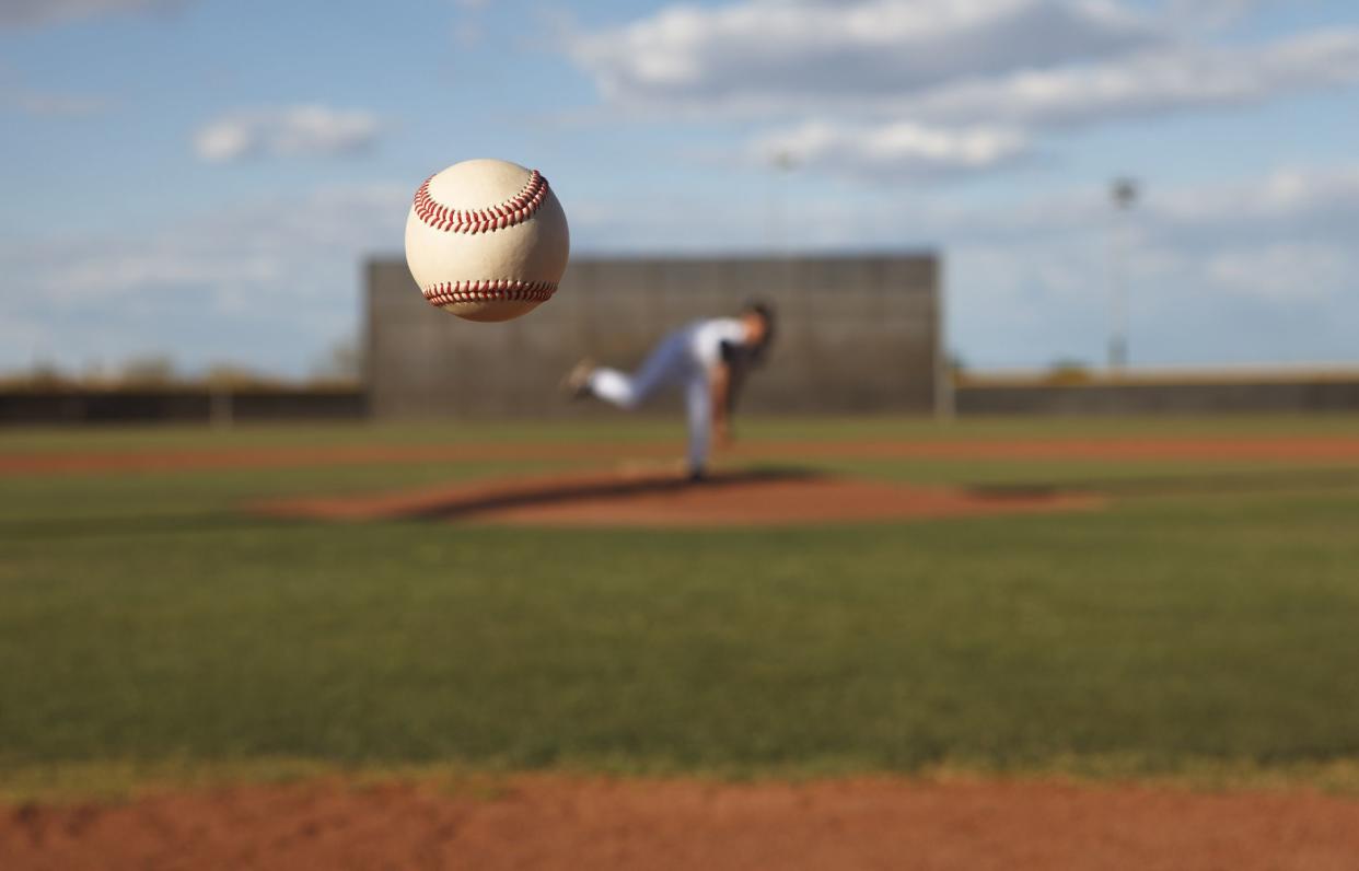 Pitcher tosses ball to home plate