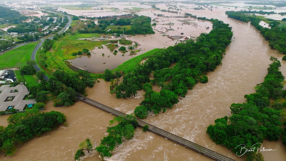 An aerial view shows flooding caused by heavy rains and water gushing through the Barron River, in Cairns, Queensland, Australia December 18, 2023. - Brent Paterson/Reuters