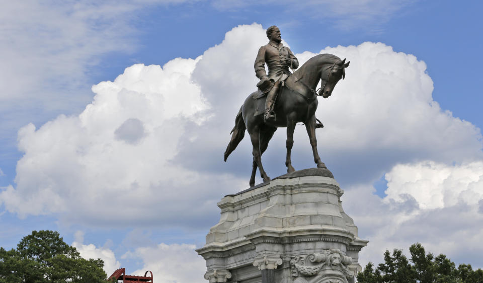 FILE - In this June 27, 2017 file photo a statue of Confederate Gen. Robert E. Lee stands in the middle of a traffic circle on Monument Avenue in Richmond, Va. If a court clears the way for the state of Virginia to take down one of the country's most prominent Confederate statues, contractors will also be removing something else from the enormous monument: a 134-year-old time capsule rumored to contain a valuable and historically significant photo of deceased President Abraham Lincoln. (AP Photo/Steve Helber)