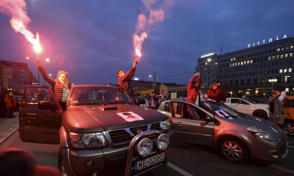 Angered women's rights activists and their supporters block rush-hour traffic at a major roundabout on the fifth day of nationwide protests against recent court ruling that tightened further Poland's restrictive abortion law, in Warsaw, Poland, on Monday, Oct. 26, 2020. The court effectively banned almost all abortions. (AP Photo/Czarek Sokolowski)