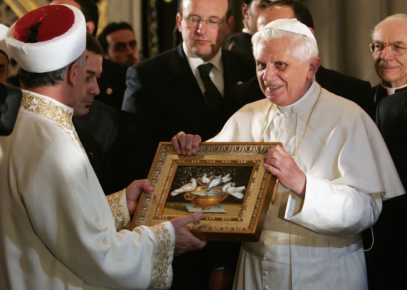 FILE PHOTO: Pope Benedict XVI offers a gift to Istanbul's Grand Mufti Mustafa Cagrici during his visit to the Blue Mosque in Istanbul