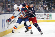 New York Islanders' Cal Clutterbuck, left, and Columbus Blue Jackets' Gregory Hofmann work along the boards during the first period of an NHL hockey game Thursday, Oct. 21, 2021, in Columbus, Ohio. (AP Photo/Jay LaPrete)