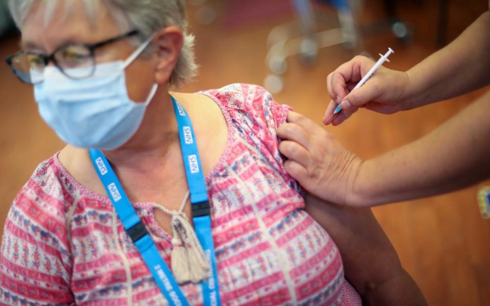 A woman receives a Covid-19 booster vaccine at Midland House in Derby on 20 September 2021 - Carl Recine/Reuters