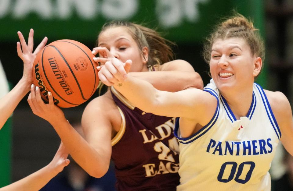 Jennings County Panthers Juliann Woodard (00) reaches for a rebound against Columbia City Eagles Molly Baker (24) on Thursday, Oct. 5, 2023, during the Hall of Fame Classic girls basketball tournament at New Castle Fieldhouse in New Castle. The Columbia City Eagles defeated the Jennings County Panthers, 56-47.