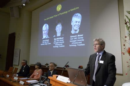 Professor Ole Kiehn presents the winners of the Nobel Prize in Medicine U.S.-British scientist John O'Keefe and Norwegian husband and wife Edvard Moser and May-Britt Moser for their discoveries of cells that constitute a positioning system in the brain, at the Karolinska Institute in Stockholm October 6, 2014. REUTERS/Bertil Ericson/TT News Agency