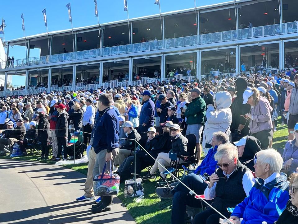 Fans flock around the 17th hole of the Players Stadium Course at TPC Sawgrass last year for completion of the first round on Saturday.