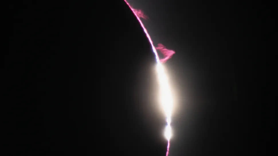  A photo of the eclipse with red plasma plumes around the sun's edge. 