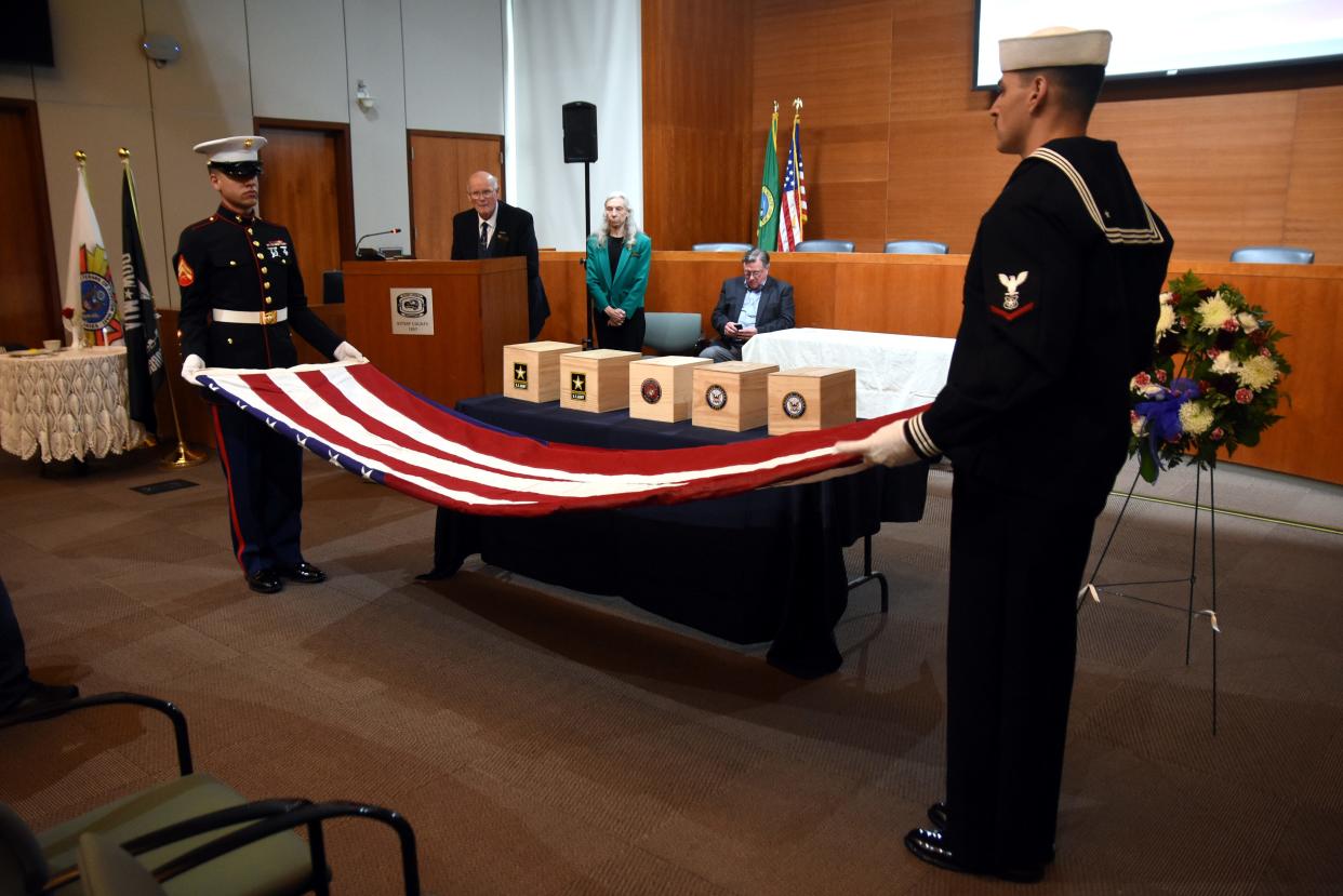 Services members fold a U.S. flag that five boxes of unclaimed remains of five deceased veterans at the annual The Unforgotten, Run to Tahoma ceremony at the Kitsap County Administration Building on May 28, 2022.