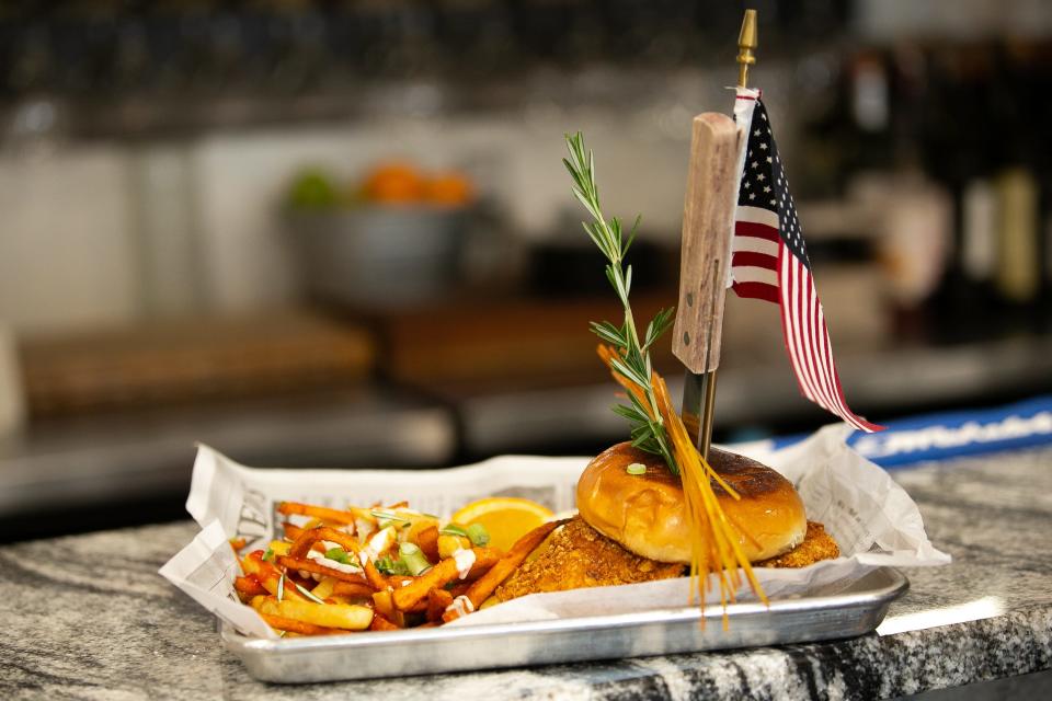 Jordan's Sage Fried Chicken is garnished with rainbow fries and a U.S. flag at Chops & Eggs Wednesday, Jan. 3, 2024.