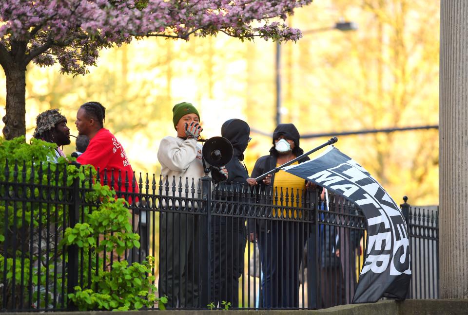 People gathered outside of Akron City Hall on April 22 after a City Council meeting concluded. They were holding signs and waiving flags in protest. Many of those standing outside of city hall held signs with Tavion Koonce-Williams' name written on them.