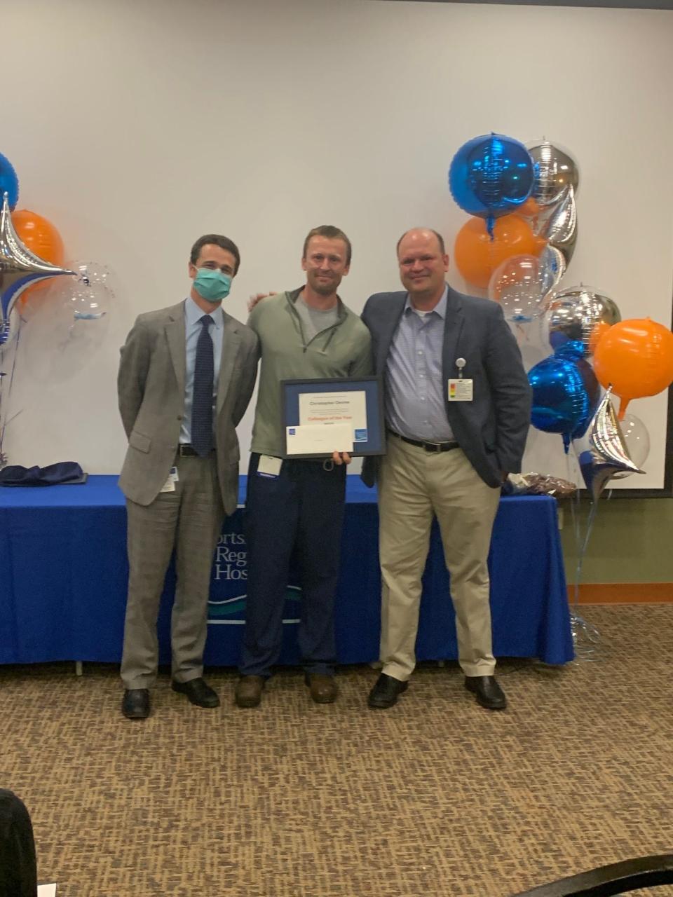 Christopher Devine of Hampton Falls received the 2021 Portsmouth Regional Hospital Colleague of the Year award for his work as a critical care pharmacist. Presenting him with the award are on left, Dean M. Carucci, CEO of PRH, and on right, Tom Wold, MD, Division Vice President of Graduate Medical Education, HCA Healthcare.