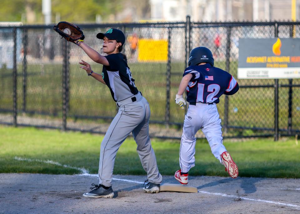 Dominic Padilla of Daves is out on a bang bang play at first base as Table 8 first baseman Nariah Tripp receives the ball a fraction of a second before Padilla's foot lands on the base.