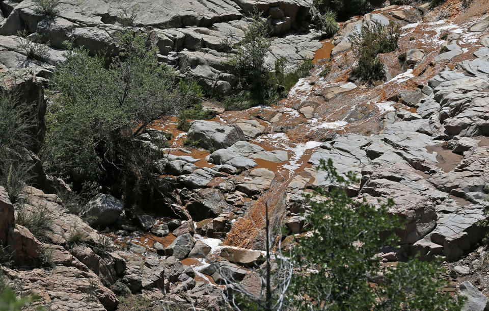 <p>The muddy water was much lower near the Water Wheel recreation area where victims were caught in a flash flood along the banks of the East Verde River Monday, July 17, 2017, in Payson, Ariz. The bodies of nearly a dozen children and adults have been found after Saturday’s flash flooding poured over a popular swimming area in the Tonto National Forest. (AP Photo/Ross D. Franklin) </p>