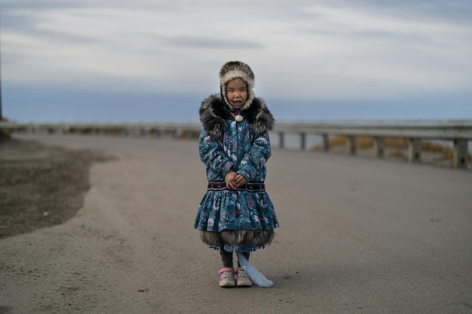 Dressed in an Inuit-style parka, Annsoph Nayokpuk, 6, stands for a photo in Shishmaref, Alaska, Wednesday, Oct. 5, 2022. (AP Photo/Jae C. Hong)