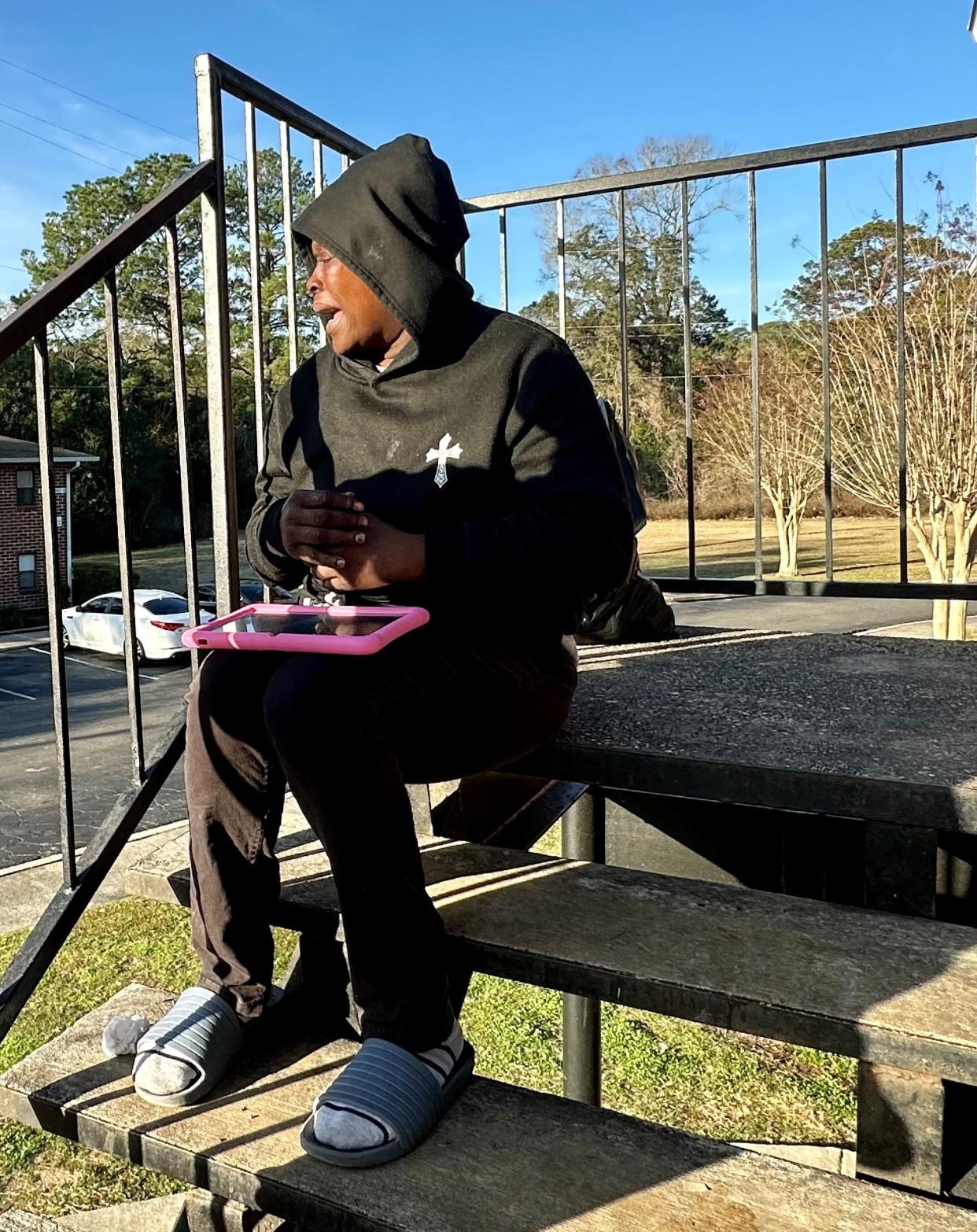 Lillian Duncan weeps on a stoop at Griffin Heights Apartment on Thursday, Jan. 18, 2024, the day after two young men were gunned down at the complex on Basin Street. Duncan said the two victims were brothers she had known for years.