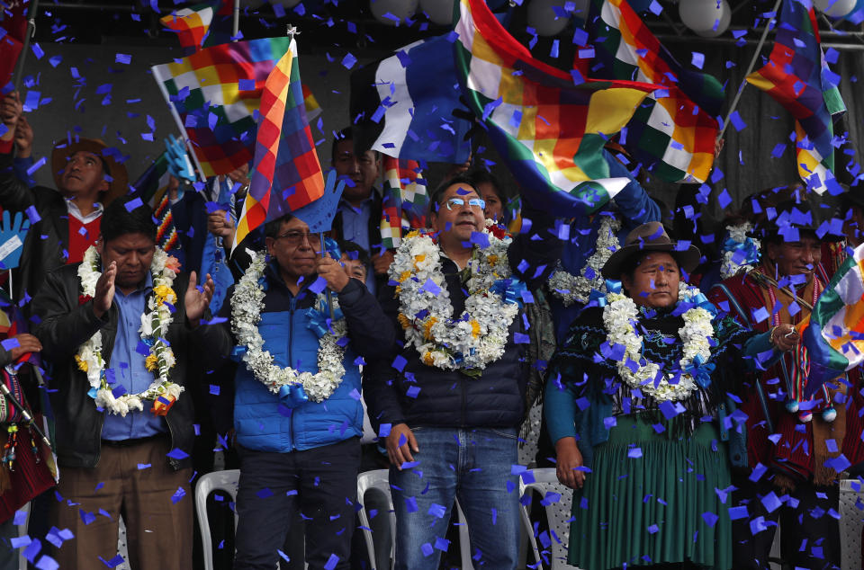 FILE - In this Feb. 8, 2020 file photo, confetti showers Luis Arce, center, Bolivian presidential candidate for the Movement Towards Socialism Party, or MAS, and running mate David Choquehuanca, second left, during their opening campaign rally, in El Alto, Bolivia. Arce was named by exiled former President Evo Morales as his party's presidential candidate. (AP Photo/Juan Karita, File)