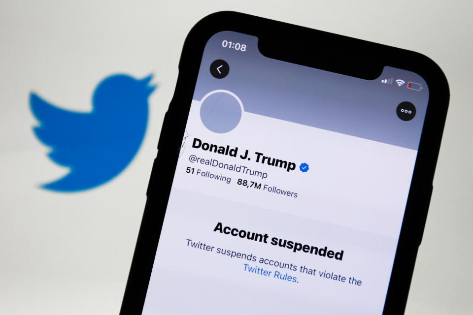 Donald Trump's Twitter account displayed on a phone screen and Twitter logo in the background are seen in this illustration photo taken in Poland on January 9, 2021. Twitter suspended Donald Trump's account because of violating the app rules. (Photo by Jakub Porzycki/NurPhoto via Getty Images)