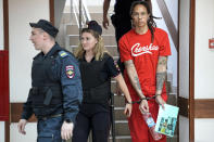FILE - WNBA star and two-time Olympic gold medalist Brittney Griner is escorted to a courtroom for a hearing in Khimki just outside Moscow, on July 7, 2022. She pleaded guilty over the summer, admitting that she had the canisters in her luggage but that she packed them inadvertently in her haste to make her flight and had no criminal intent. (AP Photo/Alexander Zemlianichenko, File)