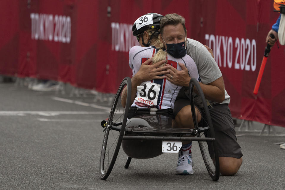 Oksana Masters, from USA, celebrates with a team member after wining at Women's H5 Road Race at the Fuji International Speedway at the Tokyo 2020 Paralympic Games, Wednesday, Sept. 1, 2021, in Tokyo, Japan. (AP Photo/Emilio Morenatti)