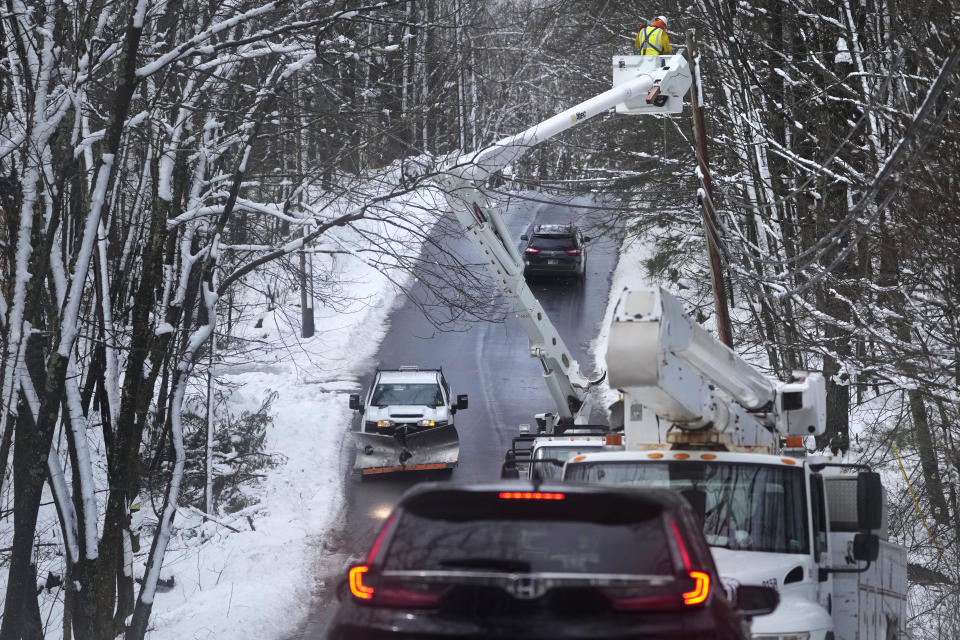 A electric utility worker strings a line, Friday, April 5, 2024, in Derry, N.H. Many New Englanders are cleaning up following a major spring storm on Thursday that brought heavy snow, rain and high winds to the Northeast. Hundreds of thousands of homes and businesses are still without power in Maine and New Hampshire. (AP Photo/Charles Krupa)