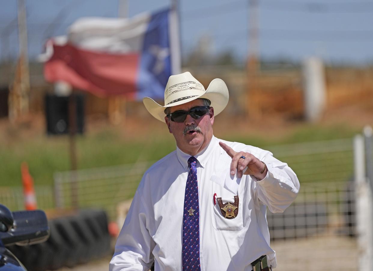 San Jacinto County Sheriff Greg Capers answers a question after a news conference, Sunday, April 30, 2023, in Cleveland, Texas. The search for a Texas man who allegedly shot his neighbors after they asked him to stop firing off rounds in his yard stretched into a second day Sunday, with authorities saying the man could be anywhere by now. The suspect fled after the shooting Friday night that left five people dead, including an 8-year-old boy. (AP Photo/David J. Phillip)