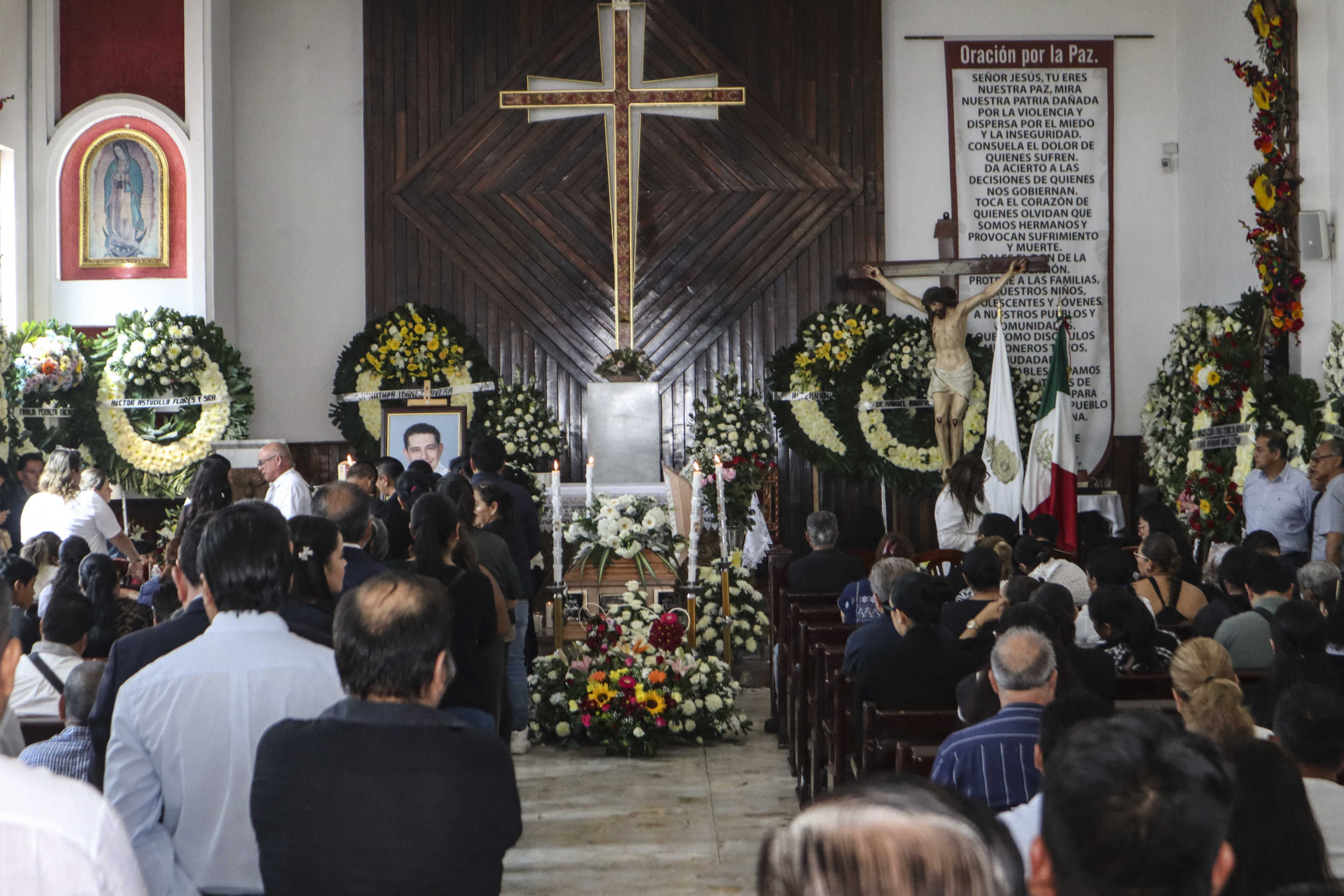 Relatives and friends of Chilpancingo Mayor Alejandro Arcos take part in a mass prior to his funeral in Chilpancingo, Guerrero State, Mexico, on October 7, 2024. The mayor of the southern Mexican city of Chilpancingo, Alejandro Arcos, was murdered on Sunday after just six days in office, a crime that could be investigated by federal prosecutors, President Claudia Sheinbaum said on Monday. (Photo by Eduardo GUERRERO / AFP) (Photo by EDUARDO GUERRERO/AFP via Getty Images)