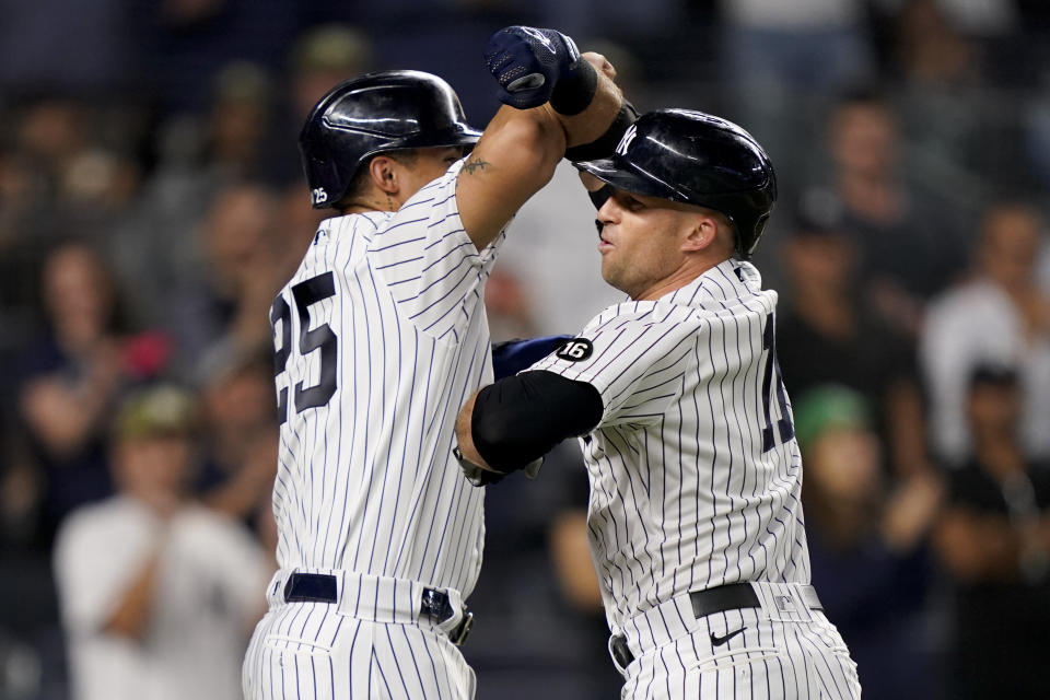 New York Yankees' Brett Gardner, right, celebrates with Gleyber Torres after hitting a three-run home run off Cleveland Indians relief pitcher Nick Wittgren during the seventh inning of a baseball game Friday, Sept. 17, 2021, in New York. (AP Photo/John Minchillo)