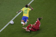 Brazil's Neymar, left, his fouled by Serbia's Nemanja Gudelj during the World Cup group G soccer match between Brazil and Serbia, at the the Lusail Stadium in Lusail, Qatar on Thursday, Nov. 24, 2022. (AP Photo/Darko Vojinovic)