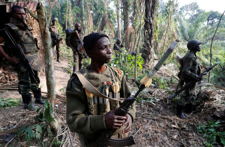 Congolese soldiers from the Armed Forces of the Democratic Republic of Congo (FARDC) stand in an ADF rebel camp, near the town of Kimbau, North Kivu Province, Democratic Republic of Congo, February 19, 2018. REUTERS/Goran Tomasevic/Files