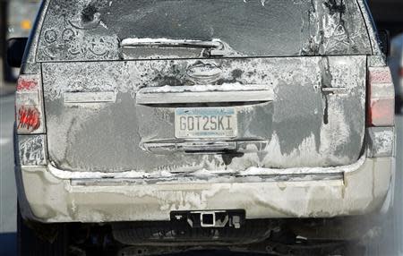 The back of a car is covered with dried road salt as it travels in Minneapolis, January 27, 2014. REUTERS/Eric Miller