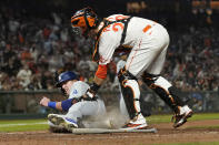 San Francisco Giants catcher Buster Posey, top, tags out Los Angeles Dodgers' Luke Raley at home during the eighth inning of a baseball game in San Francisco, Tuesday, July 27, 2021. (AP Photo/Jeff Chiu)