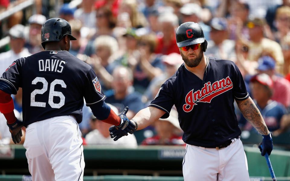 Cleveland Indians' Rajai Davis (26) celebrates his run scored as he slaps hands with Mike Napoli, right, during the first inning of a spring training baseball game against the San Diego Padres, Thursday, March 22, 2018, in Goodyear, Ariz. (AP Photo/Ross D. Franklin)