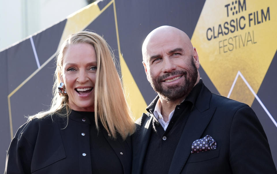 Uma Thurman, left, and John Travolta, cast members in "Pulp Fiction," pose together at a 30th anniversary screening of the film on the opening night of the 2024 TCM Classic Film Festival at TCL Chinese Theatre, Thursday, April 18, 2024, in Los Angeles. (AP Photo/Chris Pizzello)