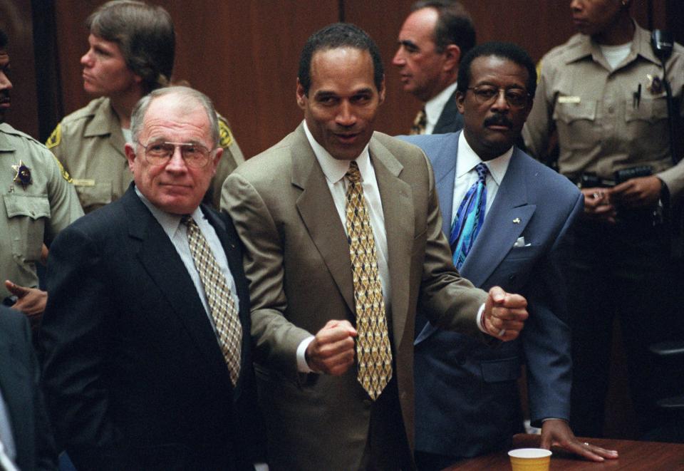 FILE - This Oct. 3, 1995 file photo shows O.J. Simpson, center, with defense attorneys F. Lee Bailey, left, and Johnnie Cochran after Simpson was found not guilty of murdering his ex-wife Nicole Brown Simpson and her friend Ron Goldman at the Criminal Courts Building in Los Angeles. Sony Electronics and the Nielsen television research company collaborated on a survey ranking TV's most memorable moments. Other TV events include, the Sept. 11 attacks in 2001, Hurricane Katrina in 2005, the Challenger space shuttle explosion in 1986 and the death of Osama bin Laden in 2011. (AP Photo/Myung J. Chun, file)