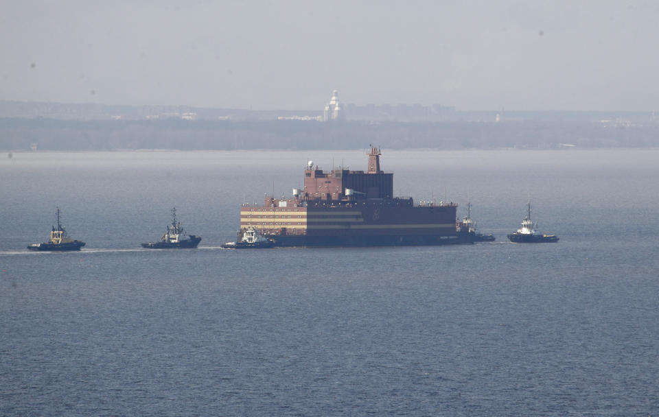 FILE - In this Saturday, April 28, 2018 file photo, the floating nuclear power plant, the 'Akademik Lomonosov', is towed out of the St. Petersburg shipyard where it was constructed in St. Petersburg, Russia. The Akademik Lomonosov that carries two 35-megawatt nuclear reactors set out Friday Aug. 23, 2019, from the Arctic port of Murmansk on the Kola Peninsula on a three-week journey to Pevek on the Chukotka Peninsula. (AP Photo/Dmitri Lovetsky, File)