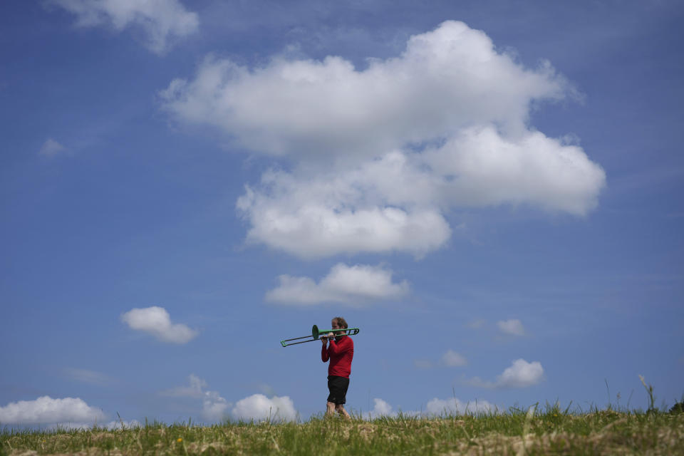 Nathaniel Dye plays trombone during an interview in London, Tuesday, June 18, 2024. Dye, who was diagnosed with bowel cancer and faced delays in treatment, is hoping the opposition Labour Party will win the July 4 election and fix problems with Britain’s National Health Service. (AP Photo/Kin Cheung)