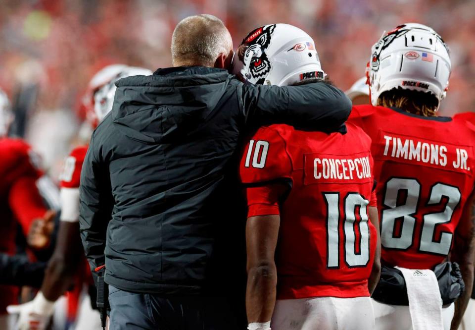 N.C. State head coach Dave Doeren hugs wide receiver KC Concepcion (10) after he scored on a six-yard touchdown reception during the first half of N.C. State’s game against UNC at Carter-Finley Stadium in Raleigh, N.C., Saturday, Nov. 25, 2023.