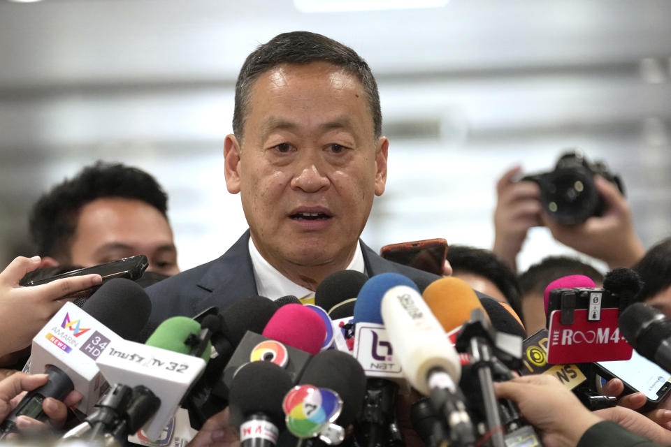 FILE- Thailand's Prime Minister Srettha Thavisin talks to reporters at Pheu Thai Party headquarters in Bangkok, Thailand, Thursday, Aug. 24, 2023. Thailand’s Constitutional Court on Thursday, May 23, accepted a petition from members of the country’s outgoing Senate to consider suspending Thavisin from office over his appointment of a Cabinet member. The court ruled that Srettha’s appointment of Pichit Chuenban as Minister of the Prime Minister’s Office was in violation of section 160 of the constitution, which bars those who have been sentenced to imprisonment or those who fail to comply with “ethical standards.” (AP Photo/Sakchai Lalit, File)