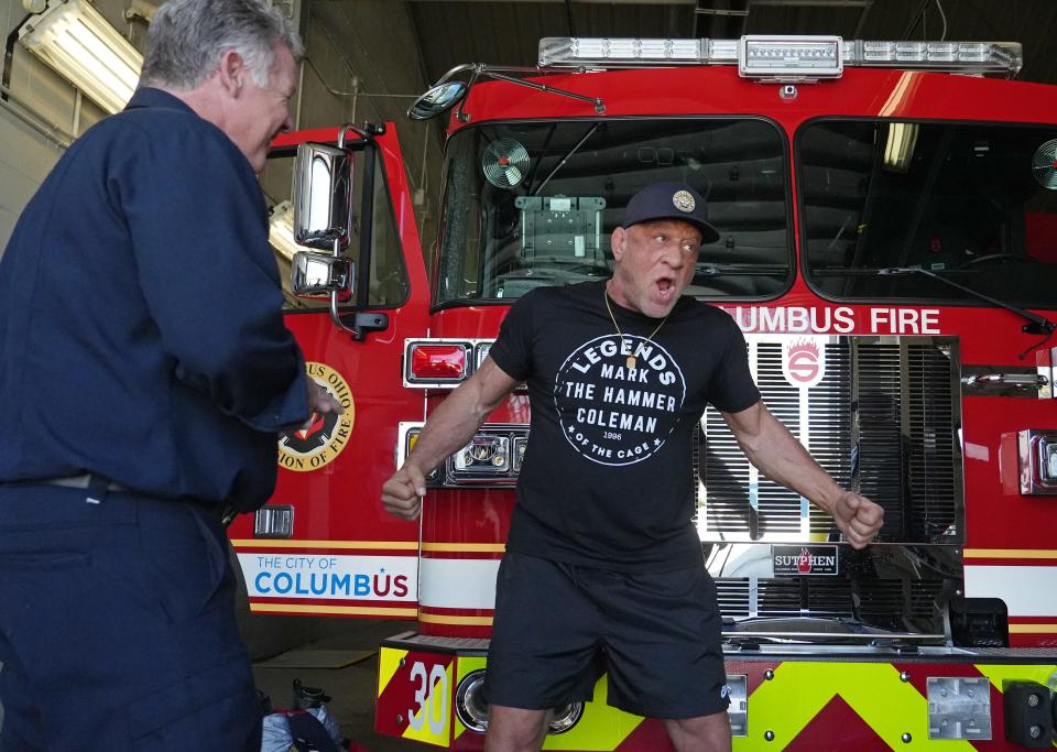 Mark Coleman, a former Ohio State University wrestler and UFC fighter known as "The Hammer" who was injured in a March house at his parents' home in Fremont, Ohio, tells stories to his friend and Columbus Fire Chief Jeff Happ. Coleman stopped by Columbus Fire Station 30 on Tuesday to talk fire safety and the importance of smoke detectors. He and Chief Happ wrestled together in school.