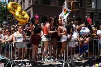 People watch as participants take part in the LGBT Pride March in the Manhattan borough of New York City, U.S., June 25, 2017. REUTERS/Carlo Allegri