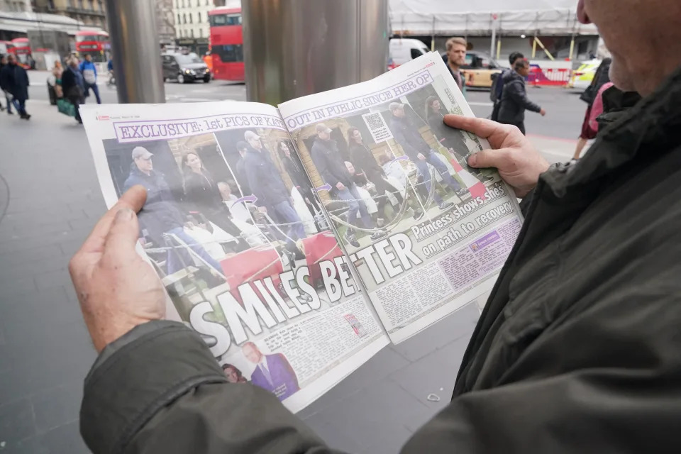 A man reads a copy of The Sun newspaper in central London which shows the Princess of Wales with the Prince of Wales during a visit to a farm shop in Windsor. Picture date: Tuesday March 19, 2024. (Photo by Jonathan Brady/PA Images via Getty Images)